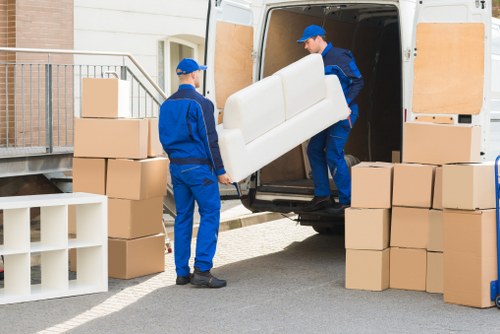 Professional movers handling furniture and fragile items during a Hook relocation