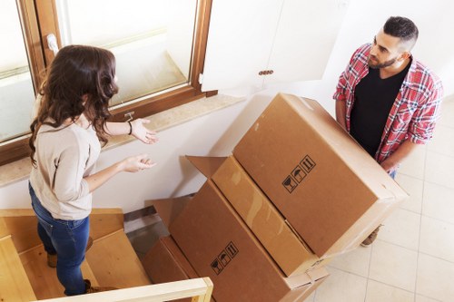 Packed boxes and furniture being loaded into a removal van