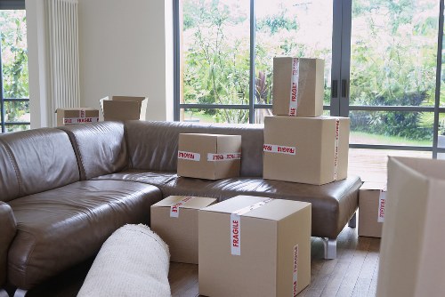 Professional movers handling desks and chairs during an office move