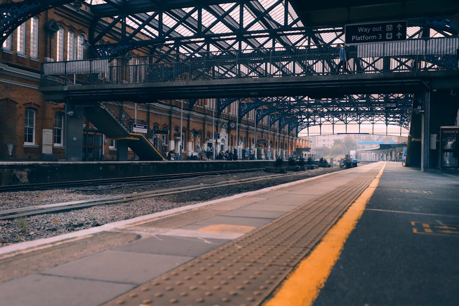 A view of multiple modern passenger trains parked on railway tracks near Hook Railway Station, with some trains in the foreground and others extending into the distance. The trains are primarily silve